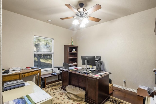 office space featuring light wood-style floors, baseboards, and ceiling fan