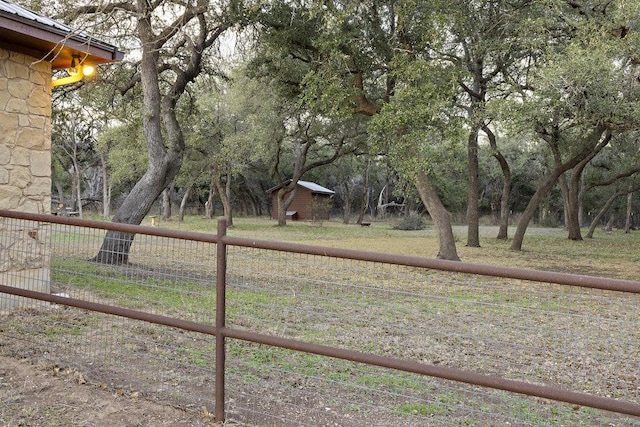 view of yard with an outbuilding and fence