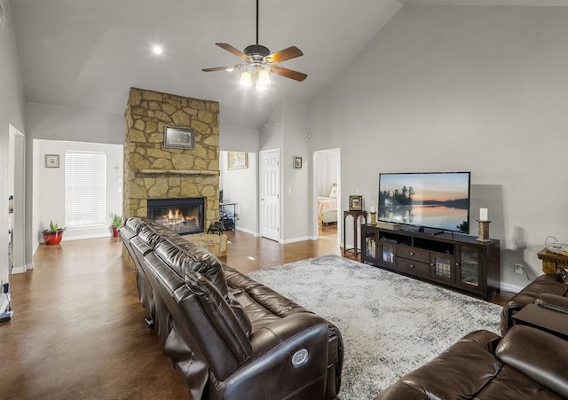 living room with baseboards, high vaulted ceiling, a stone fireplace, and a ceiling fan