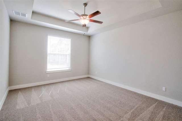 121 Pinnacle Ln, Kyle, TX 78640 - unfurnished room featuring a raised ceiling, a ceiling fan, carpet, and baseboards