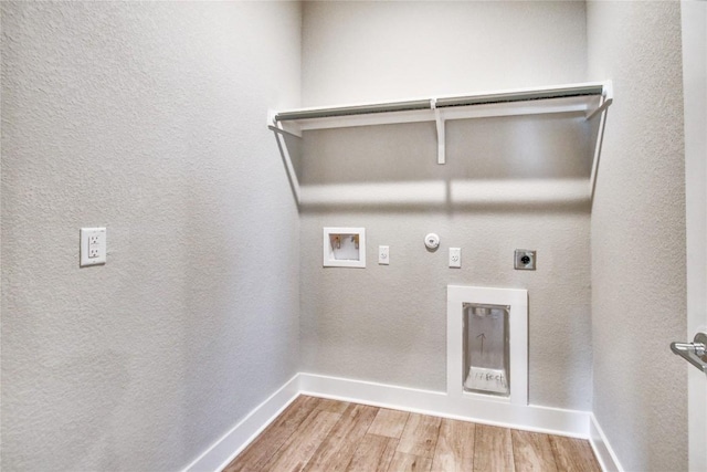 121 Pinnacle Ln, Kyle, TX 78640 - laundry room featuring gas dryer hookup, electric dryer hookup, wood finished floors, washer hookup, and baseboards