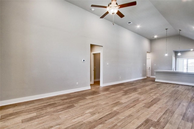 121 Pinnacle Ln, Kyle, TX 78640 - unfurnished living room with high vaulted ceiling, ceiling fan, light wood-type flooring, and baseboards