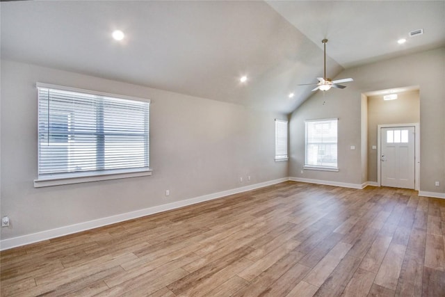 121 Pinnacle Ln, Kyle, TX 78640 - unfurnished living room featuring wood finished floors, ceiling fan, baseboards, and vaulted ceiling