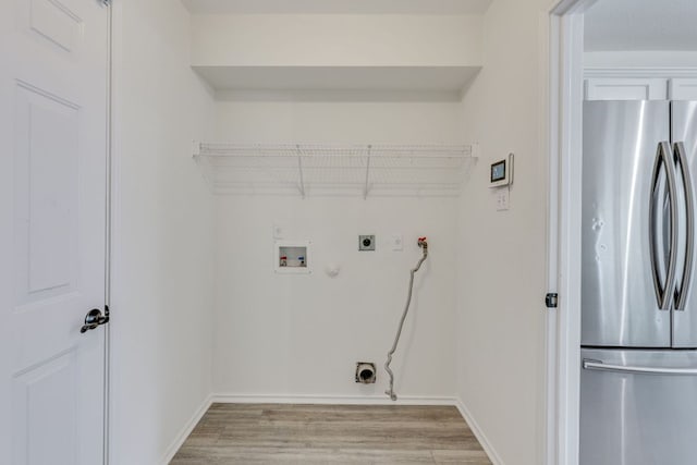 washroom with gas dryer hookup, light wood-style floors, washer hookup, and electric dryer hookup