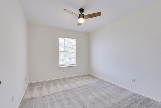 empty room with a ceiling fan, carpet flooring, and baseboards