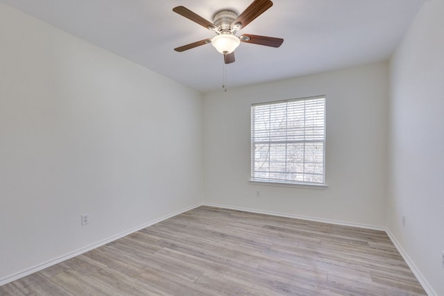 empty room featuring a ceiling fan, light wood-style flooring, and baseboards