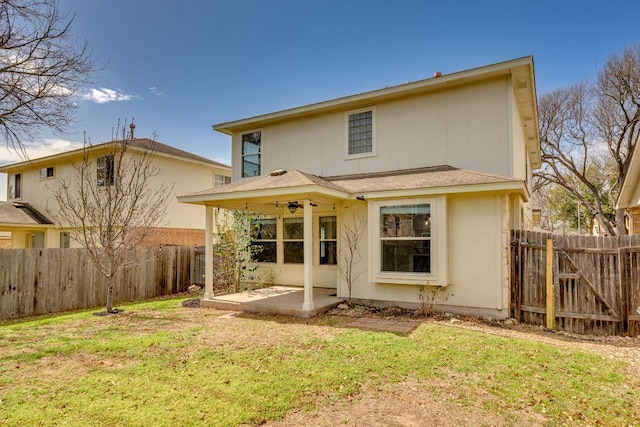 rear view of property with a yard, a patio area, and fence