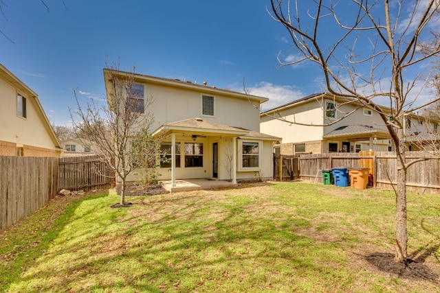 back of house with a patio area, a fenced backyard, ceiling fan, and a lawn