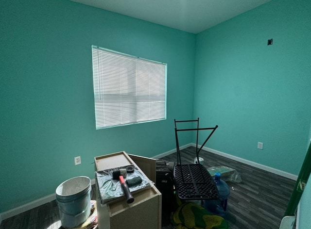 interior space with dark wood-style flooring and baseboards