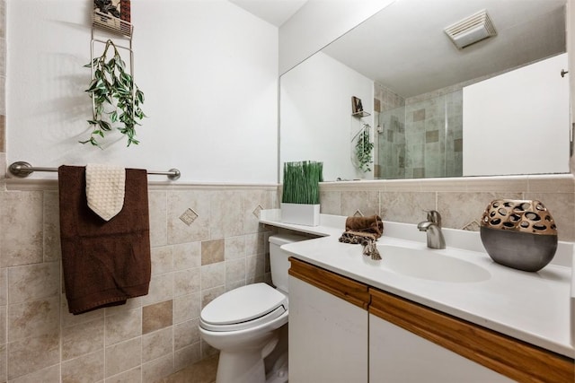 9504 Quail Village Ln, Austin, TX 78758 - full bathroom featuring tile walls, vanity, a tile shower, and wainscoting