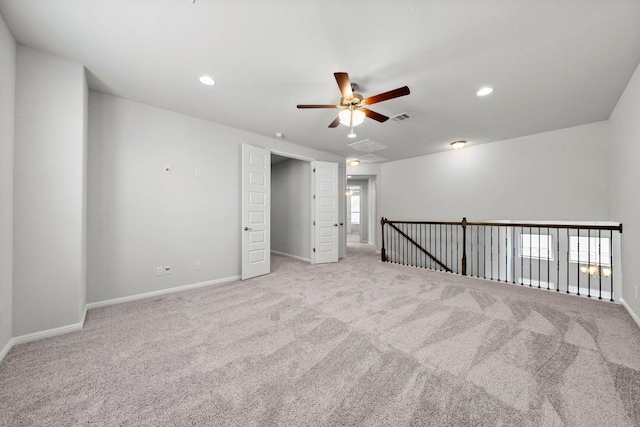 carpeted empty room with baseboards, ceiling fan, visible vents, and recessed lighting