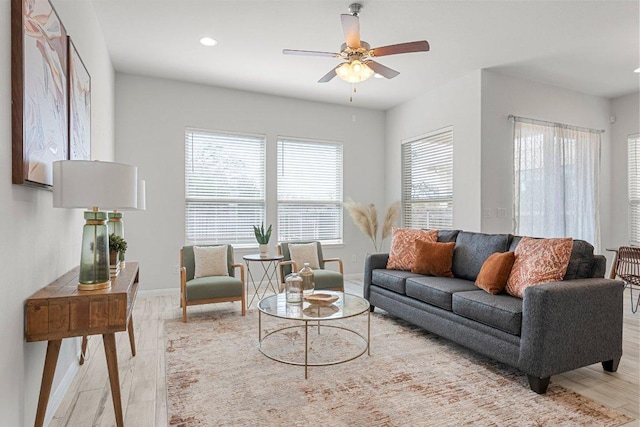 living room with light wood finished floors, ceiling fan, baseboards, and recessed lighting