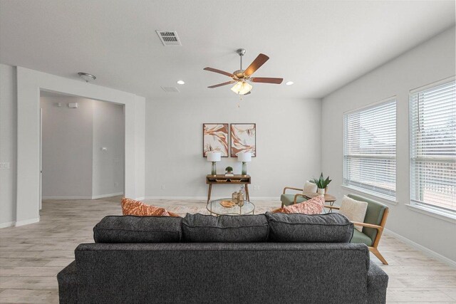 living room with baseboards, recessed lighting, light wood-style flooring, visible vents, and ceiling fan