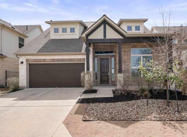 view of front facade featuring brick siding, driveway, an attached garage, and roof with shingles