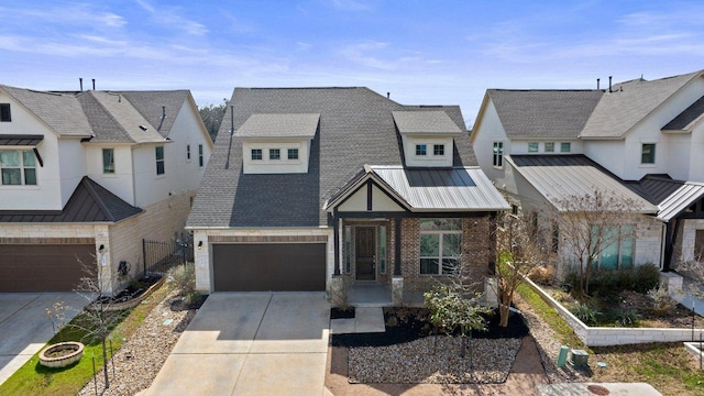 view of front facade featuring brick siding, a shingled roof, concrete driveway, a standing seam roof, and metal roof