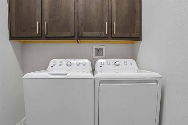 laundry area with cabinet space and washing machine and dryer