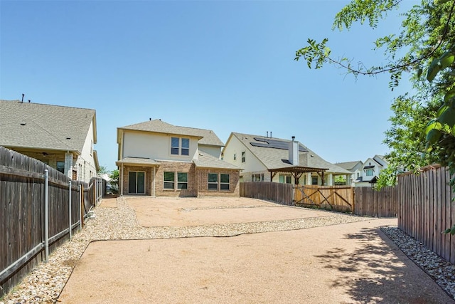 back of property with a patio, a fenced backyard, and a residential view