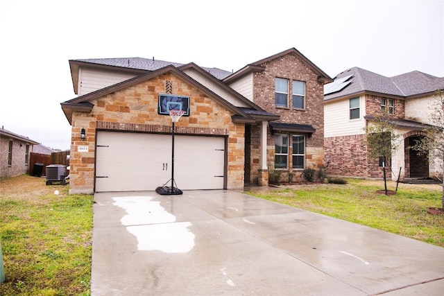 view of front of home with driveway, a garage, central AC unit, stone siding, and a front lawn