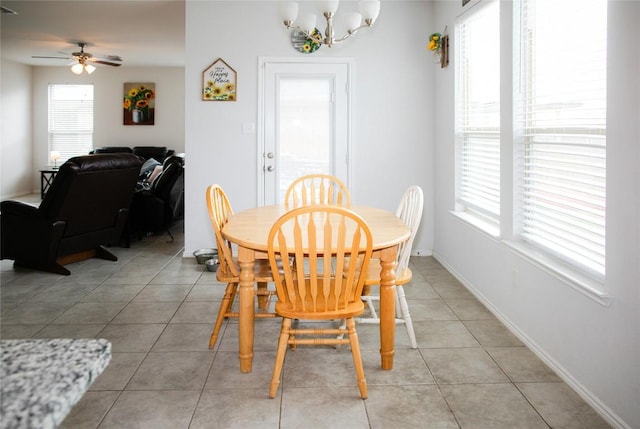 dining room with ceiling fan with notable chandelier and light tile patterned flooring