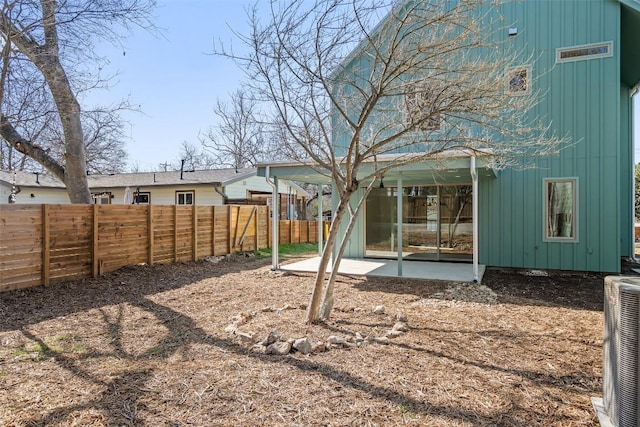 view of yard with cooling unit, visible vents, a patio, and a fenced backyard