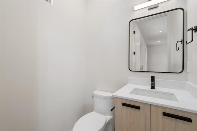 bathroom featuring vanity and toilet