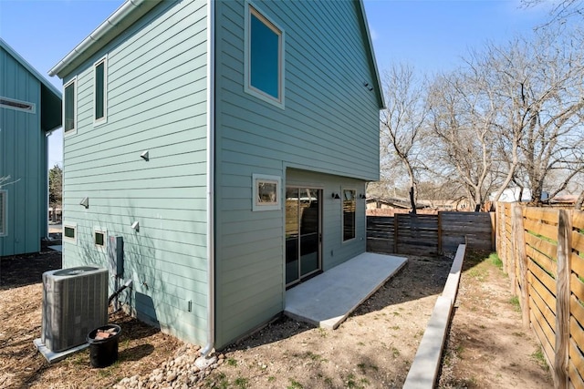 back of house with a patio area, a fenced backyard, and central AC unit