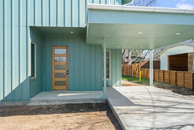 property entrance featuring fence and board and batten siding