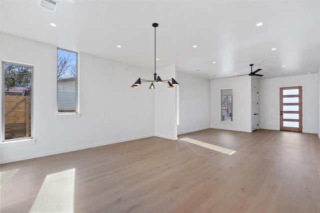 interior space featuring light wood finished floors, baseboards, visible vents, and recessed lighting