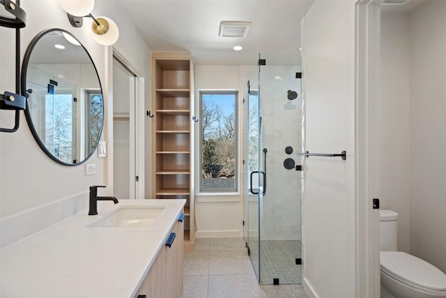 2912 Pecan Springs Rd, Austin, TX 78723 - bathroom with vanity, a shower stall, tile patterned floors, and a closet