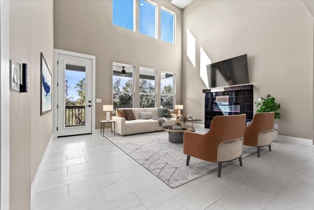 17503 Panorama Dr, Dripping Springs, TX 78620 - living area featuring a towering ceiling, healthy amount of natural light, and baseboards