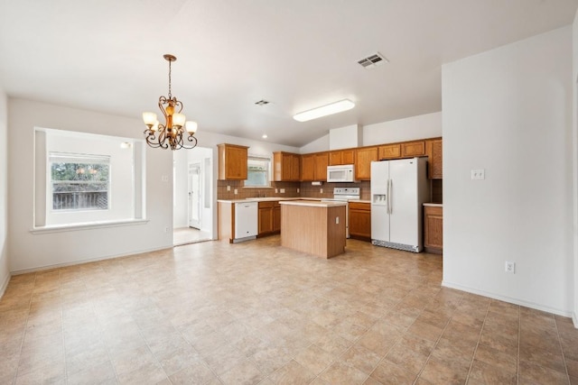 kitchen with white appliances, visible vents, a kitchen island, light countertops, and backsplash