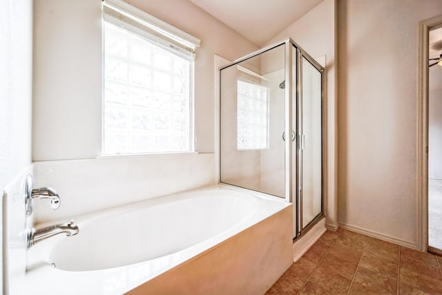 bathroom with tile patterned floors, a bath, and a shower stall