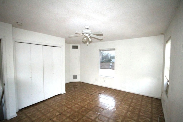 unfurnished bedroom with a closet, visible vents, and tile patterned floors