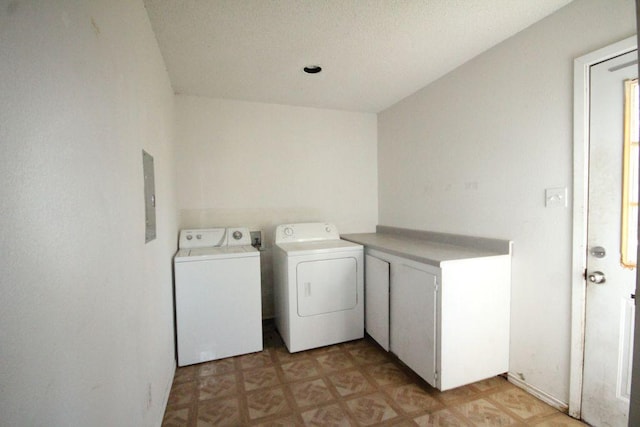 laundry area with laundry area, washing machine and dryer, and light floors