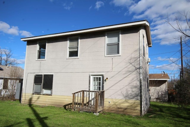 rear view of property with a yard