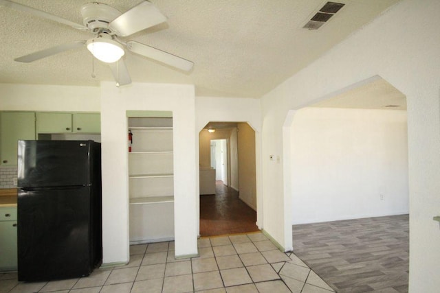 5204 Guadalupe St, Austin, TX 78751 - kitchen featuring freestanding refrigerator, arched walkways, ceiling fan, a textured ceiling, and green cabinetry