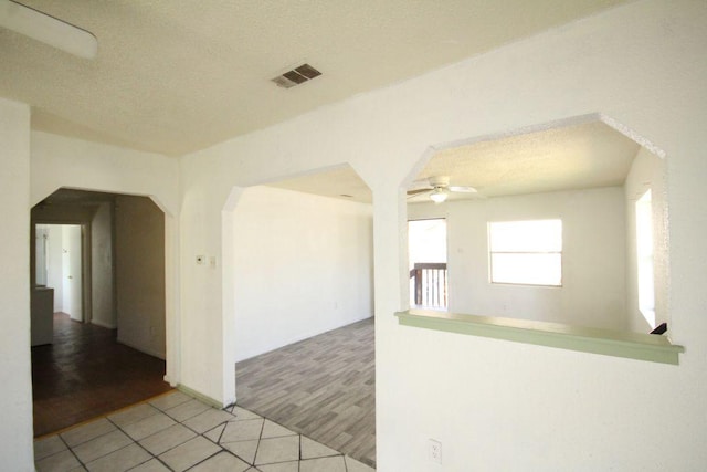5204 Guadalupe St, Austin, TX 78751 - spare room featuring light tile patterned floors, ceiling fan, and arched walkways