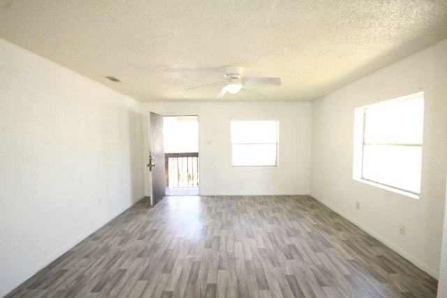 5204 Guadalupe St, Austin, TX 78751 - unfurnished room with wood finished floors, a textured ceiling, and ceiling fan