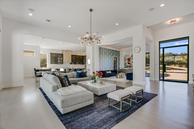 living room with a chandelier, visible vents, recessed lighting, and baseboards