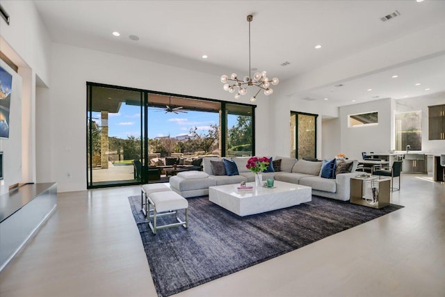 living area with a notable chandelier, visible vents, and recessed lighting