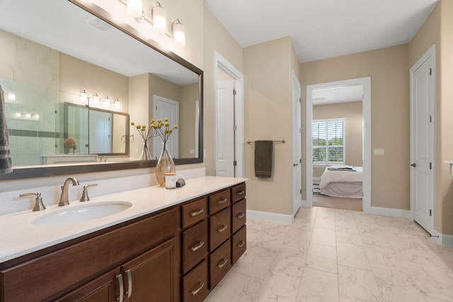 full bath with marble finish floor, vanity, baseboards, and walk in shower