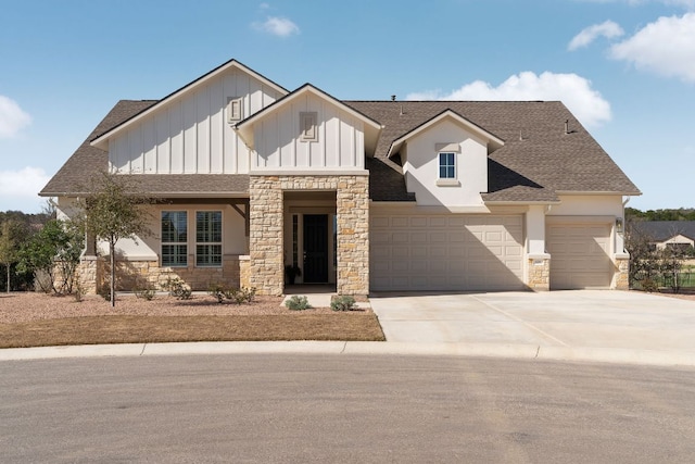 view of front facade with concrete driveway, roof with shingles, stone siding, and board and batten siding