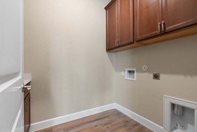 laundry room featuring cabinet space, baseboards, hookup for a gas dryer, hookup for an electric dryer, and washer hookup