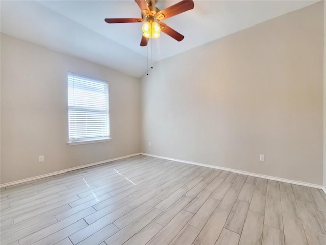 unfurnished room with light wood-type flooring, baseboards, vaulted ceiling, and a ceiling fan