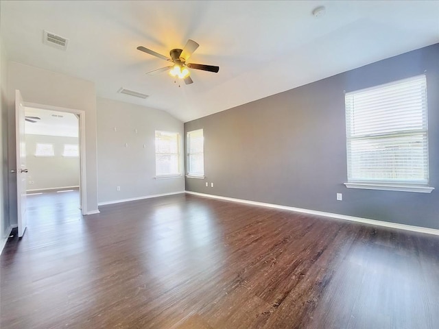 empty room with ceiling fan, dark wood-style flooring, visible vents, and baseboards