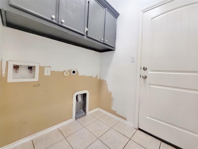 clothes washing area featuring light tile patterned floors, cabinet space, baseboards, washer hookup, and electric dryer hookup