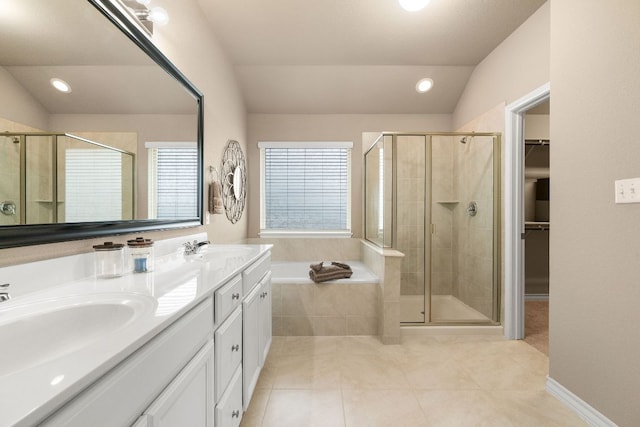 full bathroom with lofted ceiling, a stall shower, and a sink