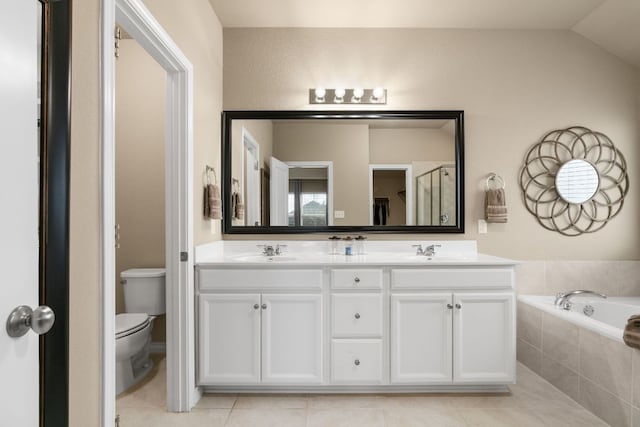 bathroom with toilet, a garden tub, a sink, and tile patterned floors