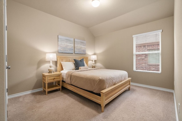 bedroom with light carpet, baseboards, and vaulted ceiling