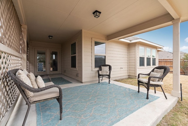 view of patio with french doors and fence